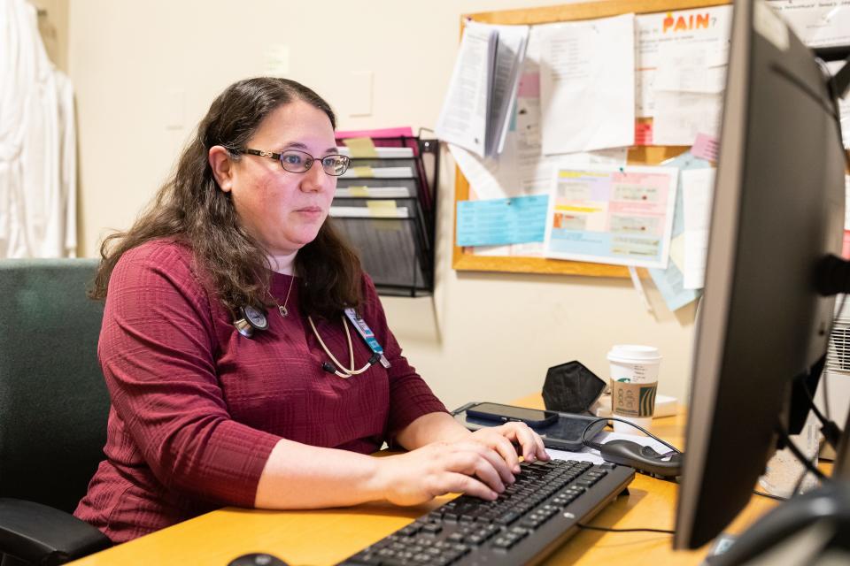 Dr. Rebecca Mishuris, an internist, edits a note generated by artificial intelligence before adding it to her patient's electronic medical record.