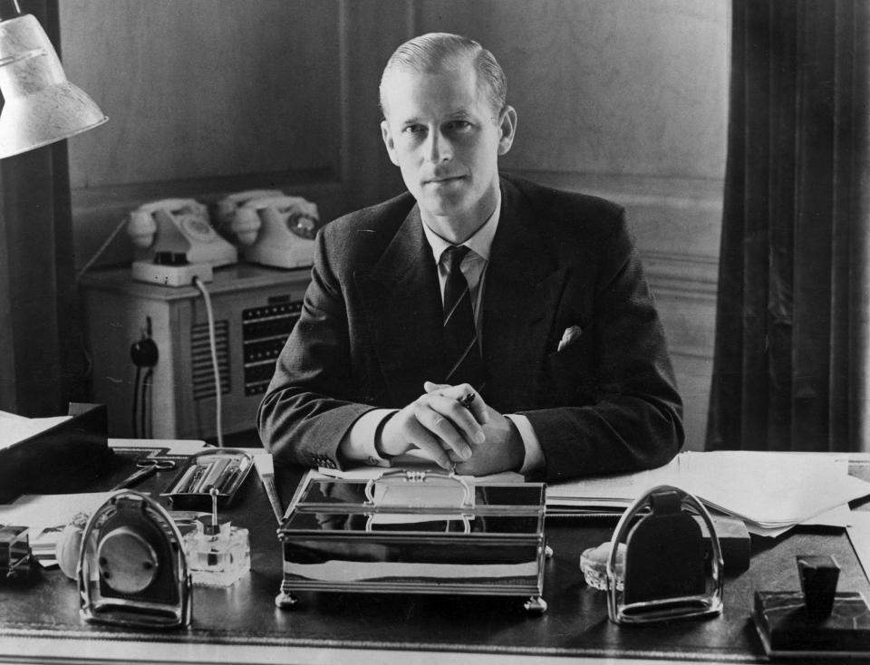 Prince Philip, the Duke of Edinburgh, sitting at his desk at Clarence House on Aug. 10, 1951. (Fox Photos / Getty Images)