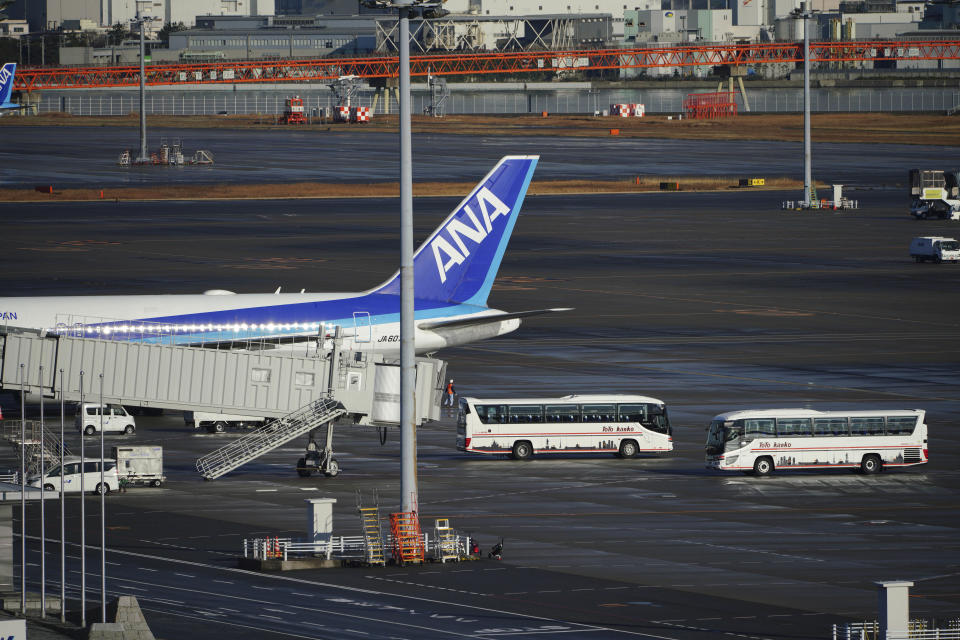 A Japanese chartered plane carrying evacuees from Wuhan, China, is parked after landing at Haneda international airport in Tokyo Wednesday, Jan. 29, 2020. (AP Photo/Eugene Hoshiko)