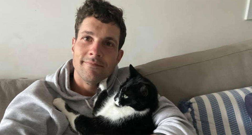 Simon Nellist seen holding a cat prior to the shark attack.