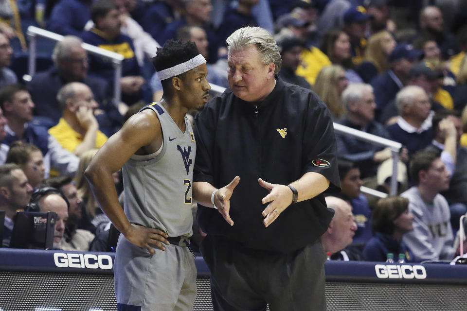 West Virginia coach Bob Huggins speaks with guard Brandon Knapper (2) after a play during the second half of an NCAA college basketball game against TCU on Tuesday, Jan. 14, 2020, in Morgantown, W.Va. (AP Photo/Kathleen Batten)