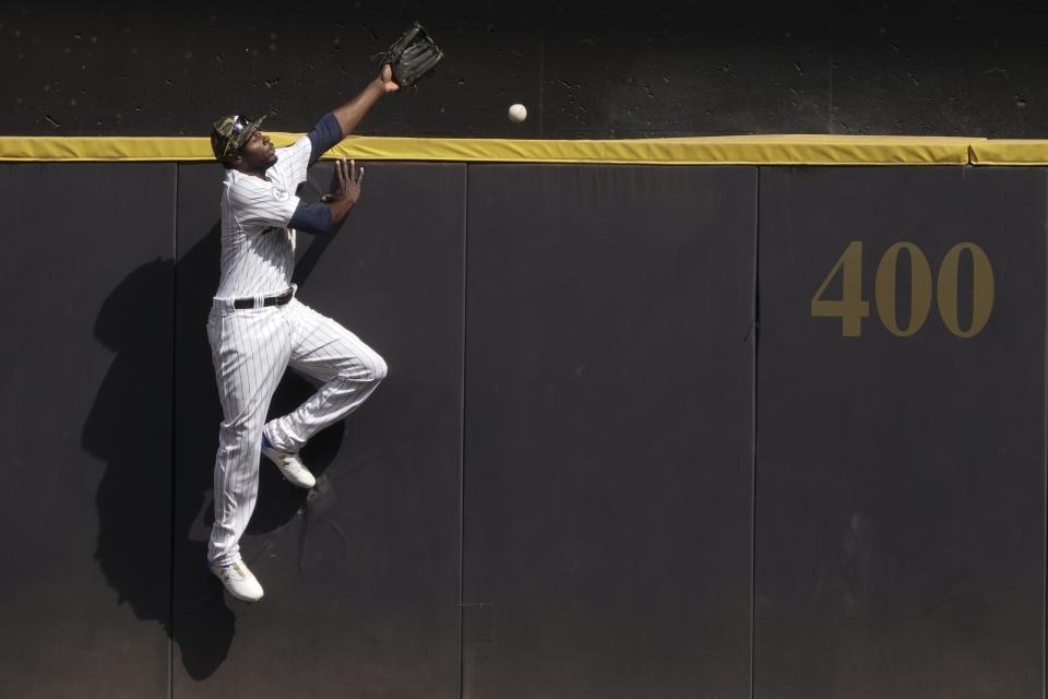 Milwaukee Brewers' Lorenzo Cain can't catch a grand slam hit by Atlanta Braves' Freddie Freeman during the seventh inning of a baseball game Sunday, May 16, 2021, in Milwaukee. (AP Photo/Morry Gash)