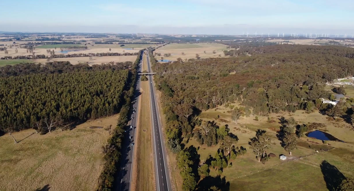 An aerial shot of the plantation to the left, the freeway in the middle, and more bushland to right.