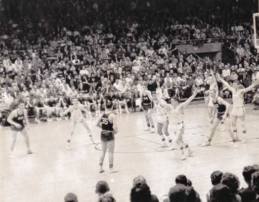 East Rochester, wearing black jerseys, controls possession as Lyons senior Jim Boeheim plays defense near the top of the key. East Rochester upset Lyons 58-57 in double overtime of the Section V Class AA final March 24, 1962 at the War Memorial.