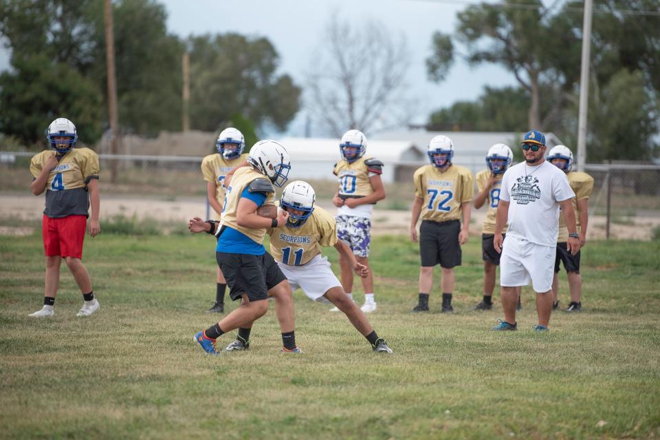 The Dolores Huerta Prepartory Academy football team run blocking drills during practice on Wednesday, August 16, 2023.