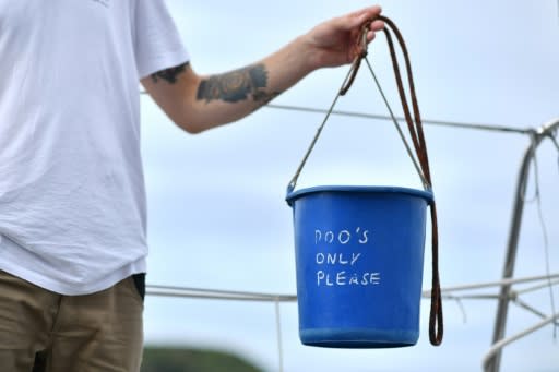 The toilet is a blue plastic bucket, complete with a biodegradable bag that can be thrown overboard