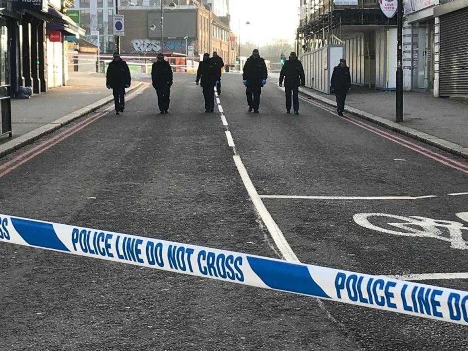 Police scour the scene of Sutton stabbing (Supplied)