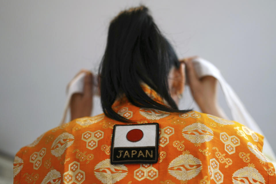 Olympic super-fan Kyoko Ishikawa wears a cheering headband with Japanese words "Confident victory" around her head Saturday, April 10, 2021, in Tokyo. Ishikawa, president of an IT company, has attended every Summer Olympics since Barcelona in 1992, becoming famous as an unofficial "International Olympic Cheerleader." She relishes joining in with fans from everywhere to cheer for their athletes. (AP Photo/Eugene Hoshiko)