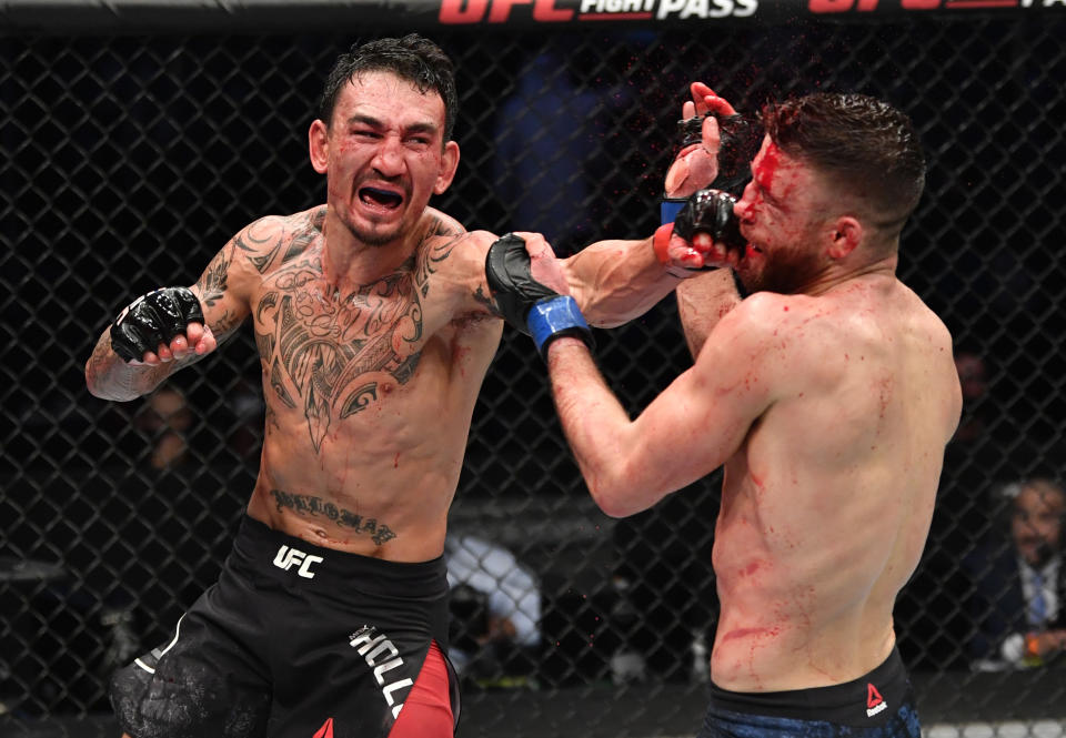 ABU DHABI, UNITED ARAB EMIRATES - JANUARY 17: (L-R) Max Holloway punches Calvin Kattar in a featherweight bout during the UFC Fight Night event at Etihad Arena on UFC Fight Island on January 17, 2021 in Abu Dhabi, United Arab Emirates. (Photo by Jeff Bottari/Zuffa LLC)