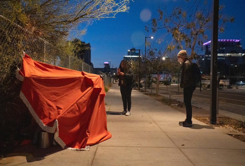 Nicky Stevens (center) and Kelli Williams (right, both with MAG) check a shelter during Maricopa County's annual Point-in-Time count, Jan. 25, 2022, near First and Moreland streets in Phoenix.