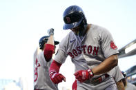 Boston Red Sox's Xander Bogaerts, right, celebrates after hitting a grand slam against the Minnesota Twins during the third inning of a baseball game Wednesday, Aug. 31, 2022, in Minneapolis. (AP Photo/Abbie Parr)