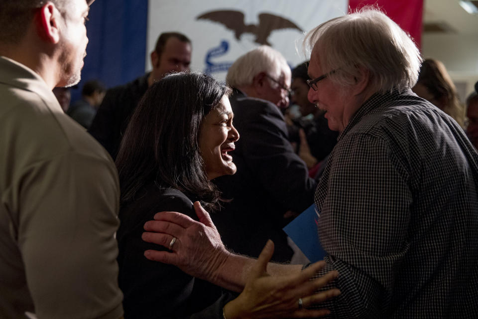 U.S. Rep. Pramila Jayapal, D-Wash, center left, and Democratic presidential candidate Sen. Bernie Sanders, I-Vt., background center, greet members of the audience at a campaign stop at the State Historical Museum of Iowa, Monday, Jan. 20, 2020, in Des Moines, Iowa. (AP Photo/Andrew Harnik)
