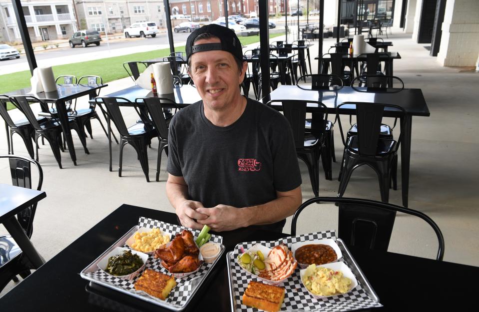 Moe's Original BBQ is an Alabama-style BBQ restaurant now open in Spartanburg Sam Ragland and John Wood are partners in the restaurant. This is Sam Ragland on the patio with dishes from the  restaurant.