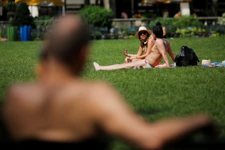 People sunbathe during hot weather day in Bryant Park in Manhattan, New York, U.S., July 1, 2018. REUTERS/Eduardo Munoz