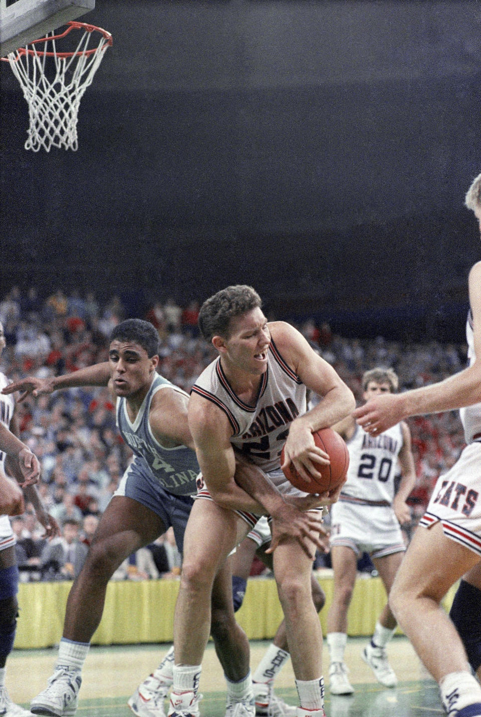 Arizona Wildcats center Tom Tolbert (right) struggles to keep control of the ball as North Carolina Tar Heels forward Rick Fox (left) takes a stab at the ball in the second half of Sunday’s NCAA West Regional Championship game in Seattle, March 27, 1988. AP Photo/Reed Saxon