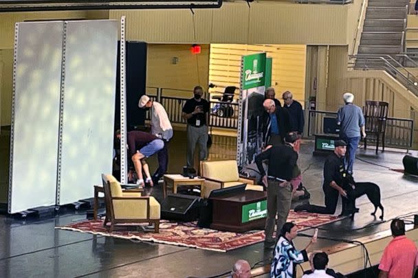 PHOTO: Author Salman Rushdie, behind screen left, is tended to after he was attacked during a lecture, Aug. 12, 2022, at the Chautauqua Institution in Chautauqua, N.Y. (Joshua Goodman/AP)