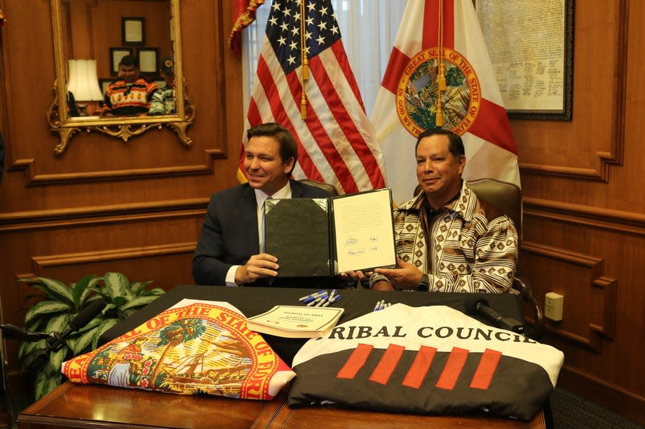 Gov. Ron DeSantis and Marcellus Osceola, Jr., chairman of the Seminole Tribe of Florida, pose for a photo at a signing ceremony on Friday, April 23, 2021.