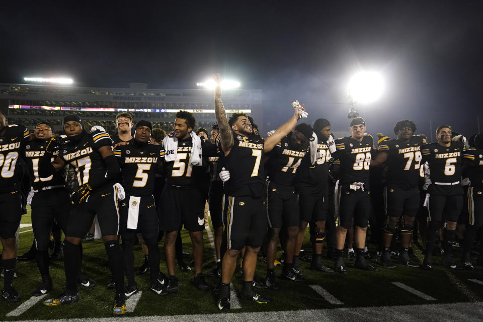 Missouri running back Cody Schrader (7) celebrates with teammates following an NCAA college football game against Florida Saturday, Nov. 18, 2023, in Columbia, Mo. Missouri won 33-31. (AP Photo/Jeff Roberson)