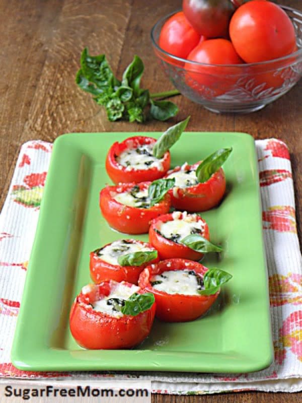 <p>Sugar Free Mom</p><p>Stuffed with fresh basil and mozzarella, this pretty dish epitomizes summer caprese salads!</p><p><a href="http://www.sugarfreemom.com/recipes/baked-cheesy-tomato-basil-cups/" rel="nofollow noopener" target="_blank" data-ylk="slk:Get the recipe!;elm:context_link;itc:0;sec:content-canvas" class="link rapid-noclick-resp">Get the recipe!</a></p>