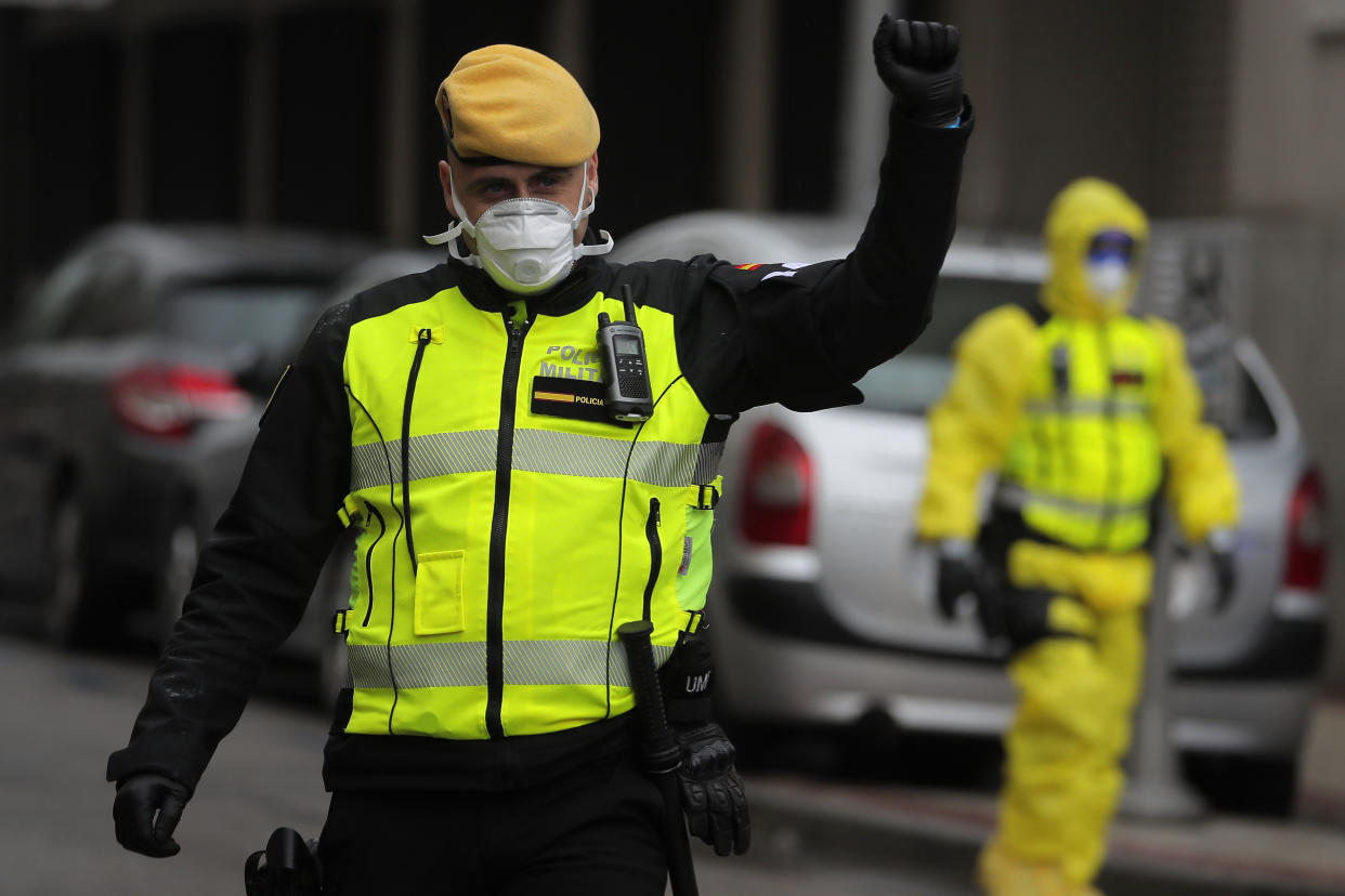 Members of the UME (Emergency Army Unit) wearing face masks and protective suit to protect from coronavirus A member of the UME (Emergency Army Unit) wearing a protective suit to protect from the coronavirus stands near a bus carrying patients infected with the COVID-19 waiting to be transported from Gregorio Maranon hospital to a temporary hospital set up at the IFEMA convention centre in Madrid, Spain, Wednesday, April 1, 2020. Facing intense surges in the need for hospital ICU beds, European nations are on a hospital-building and medical worker-hiring spree. They are throwing together makeshift hospitals and shipping coronavirus patients out of overwhelmed cities. The new coronavirus causes mild or moderate symptoms for most people, but for some, especially older adults and people with existing health problems, it can cause more severe illness or death. (AP Photo/Manu Fernandez)