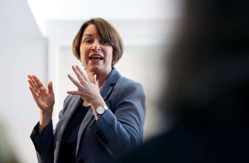 In this Sunday, Feb. 24,  photo, U.S. Sen. Amy Klobuchar, D-Minn., speaks to voters during a campaign stop at a home in Nashua, N.H. U.S. Sen. and presidential hopeful Klobuchar has built a reputation as an effective champion for consumer safety. She also aggressively advocated for the medical device industry - a big employer in her home state of Minnesota - in ways that complicate her reputation as a consumer defender. Some consumer advocates say her work has helped put patients at risk.