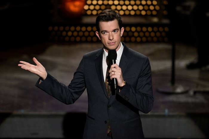 John Mulaney onstage in his signature suit