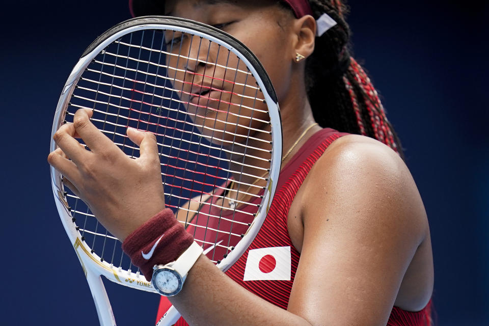 FILE - In this July 26, 2021 file photo, Naomi Osaka, of Japan, adjusts her racket during a second round tennis match against Viktorija Golubic, of Switzerland, at the 2020 Summer Olympics, in Tokyo, Japan. Osaka and Simone Biles are prominent young Black women under the pressure of a global Olympic spotlight that few human beings ever face. But being a young Black woman -- which, in American life, comes with its own built-in pressure to perform -- entails much more than meets the eye. (AP Photo/Patrick Semansky, File)