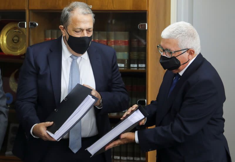 Myron Nicolatos, former Cyprus Chief Justice, hands over findings to Attorney-General Georgios Savvides in Nicosia