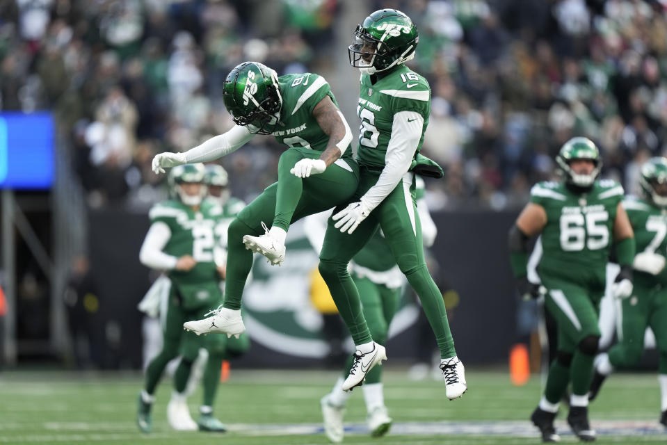 New York Jets wide receiver Elijah Moore (8) and wide receiver Jeff Smith (16) celebrate after a play against the Detroit Lions during the second quarter of an NFL football game, Sunday, Dec. 18, 2022, in East Rutherford, N.J. (AP Photo/Bryan Woolston)