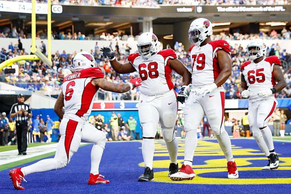 James Conner #6 celebrates with Kelvin Beachum #68 and Josh Jones #79 of the Arizona Cardinals after scoring a touchdown in the second quarter of the game against the Los Angeles Rams at SoFi Stadium on November 13, 2022, in Inglewood, California.