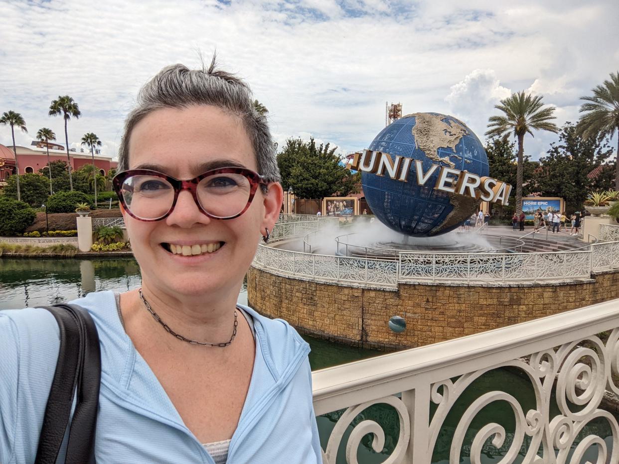 cindy taking a selfie in front of the universal globe sign at universal orlando