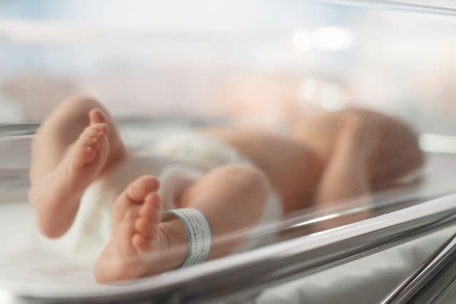 <p>Getty</p> Stock image of a newborn baby lying in a bassinet