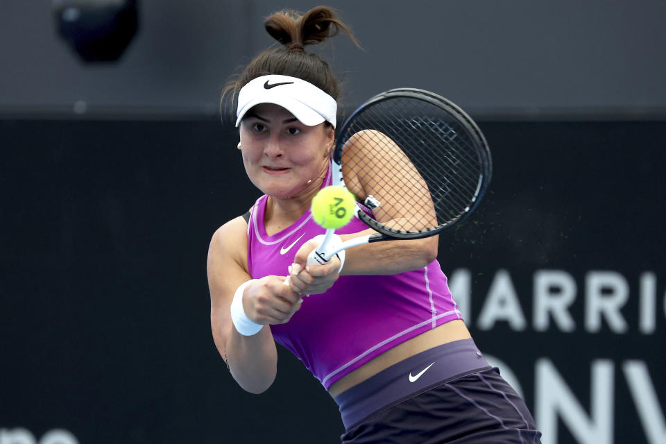 Canada's Bianca Andreescu makes a backhand return to Spain's Garbiñe Muguruza during their Round of 32 match at the Adelaide International tennis tournament in Adelaide, Australia, Sunday, Jan. 1, 2023. (AP Photo/Kelly Barnes)