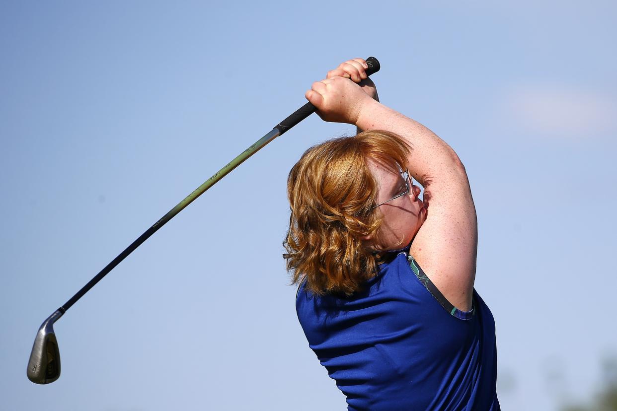 In this Aug. 28, 2019, photo, Amy Bockerstette, who had Down syndrome, practices with her teaching pro at Palmbrook Country Club in Sun City, Ariz.  Parents of children with Down syndrome are often told what their children can't do. Joe and Jenny Bockerstette quickly realized all Amy could do. She had good hand-eye coordination. Perhaps more importantly, she had determination. (AP Photo/Ross D. Franklin)