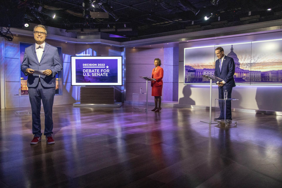 Spectrum News 1 political anchor Tim Boyum, left, prepares to moderate a televised debate between Democratic candidate for U.S. Senate Cheri Beasley, center, and Republican challenger U.S. Rep. Ted Budd, R-N.C., Friday, Oct. 7, 2022, at Spectrum News 1 studio in Raleigh, N.C. (Travis Long/The News & Observer via AP, Pool)