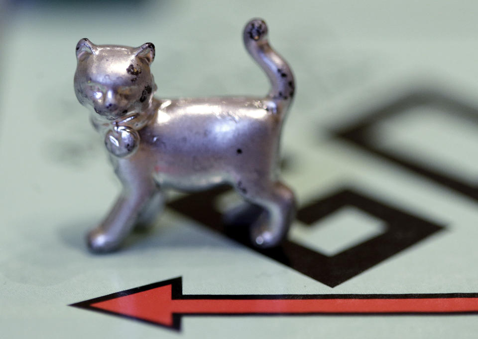 FILE - This Feb. 5, 2013 file photo shows a cat token, the newest Monopoly token on the game board at Hasbro Inc. headquarters, in Pawtucket, R.I. Hasbro has released a limited "house rules" edition of the popular board game. (AP Photo/Steven Senne, File)