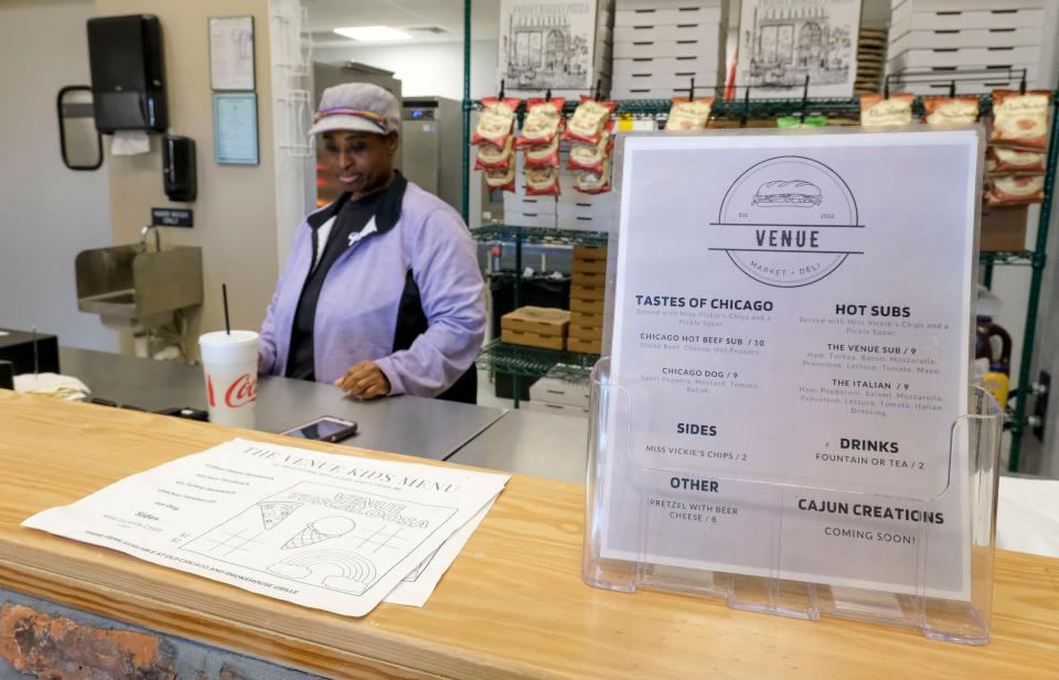 Mar 14, 2023; Tuscaloosa, AL, USA;  Tarzanna McKinney minds the counter at the market and deli at The Venue, a collection of restaurants, a bar, and entertainment venue on Watermelon Rd. in Tuscaloosa.