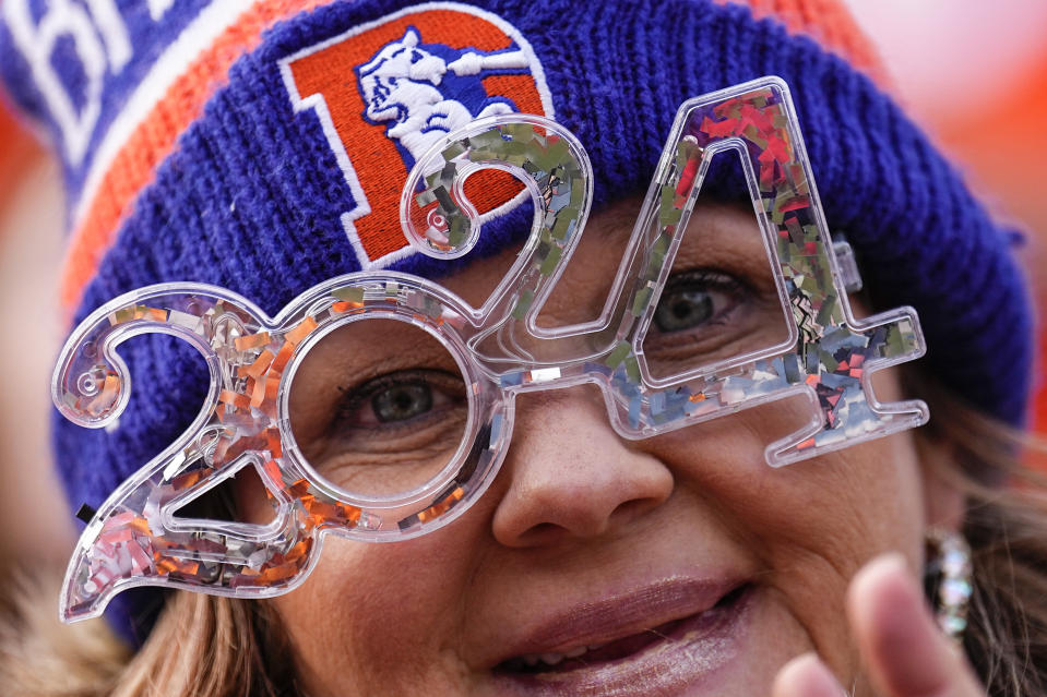 Fans cheer during the first half of an NFL football game between the Denver Broncos and the Los Angeles Chargers, Sunday, Dec. 31, 2023, in Denver. (AP Photo/Jack Dempsey)