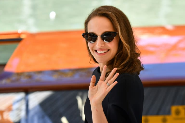 Actress Natalie Portman waves as she arrives by boat for the Venice film festival