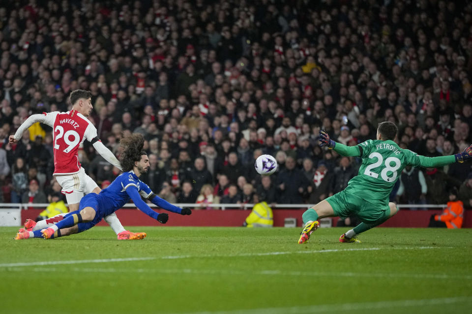 Arsenal's Kai Havertz, left, scores his side's third goal during the English Premier League soccer match between Arsenal and Chelsea at Emirates Stadium in London, Tuesday, April 23, 2024. (AP Photo/Kin Cheung)