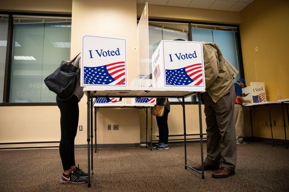 People fill out their ballots at an early voting site in Arlington, Va., in 2020.