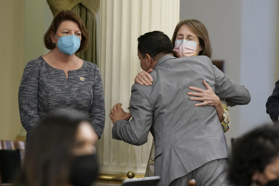 California Assembly Speaker Anthony Rendon, center, hugs state Sen. Nancy Skinner, D-Berkeley, right after the Assembly approved a measure to put a constitutional amendment on the November ballot, co-authored by Rendon and state Sen. Pro Tempore Toni Atkins, left, that would guarantee the right to an abortion and contraceptives, at the Capitol in Sacramento, Calif., Monday, June 27, 2022. The vote comes three days after the U.S. Supreme Court overruled Roe v. Wade. (AP Photo/Rich Pedroncelli)