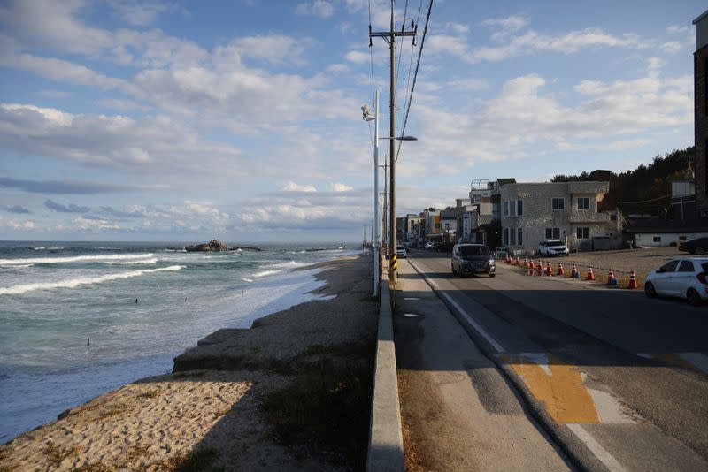 Houses, cafes and a concrete road are seen next to erosion-affected Sacheon beach where there used to be a long sand beach, in Gangneung