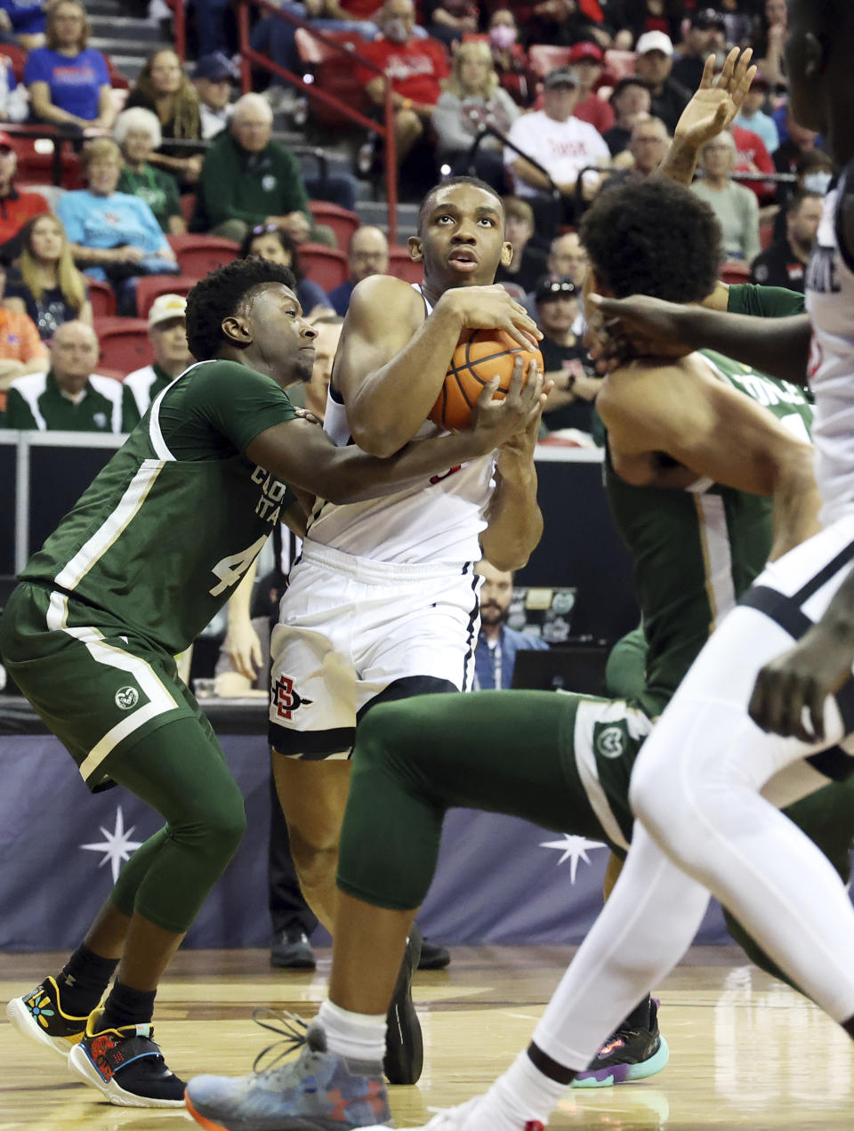 San Diego State guard Lamont Butler (5) is fouled on by Colorado State guard Isaiah Stevens (4) during the first half of an NCAA college basketball game in the quarterfinals of the Mountain West Conference Tournament, Thursday, March 9, 2023, in Las Vegas. (AP Photo/Ronda Churchill)
