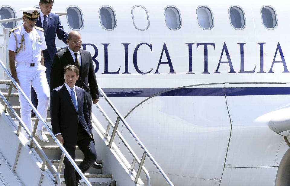 Italy's Prime Minister Giuseppe Conte, foreground, arrives at the airport in Addis Ababa, Ethiopia Thursday, Oct. 11, 2018 for a bilateral visit to the country. The two parties will have bilateral discussions on trade, investment, and other matters according to Ethiopia's Prime Minister's office. (AP Photo)