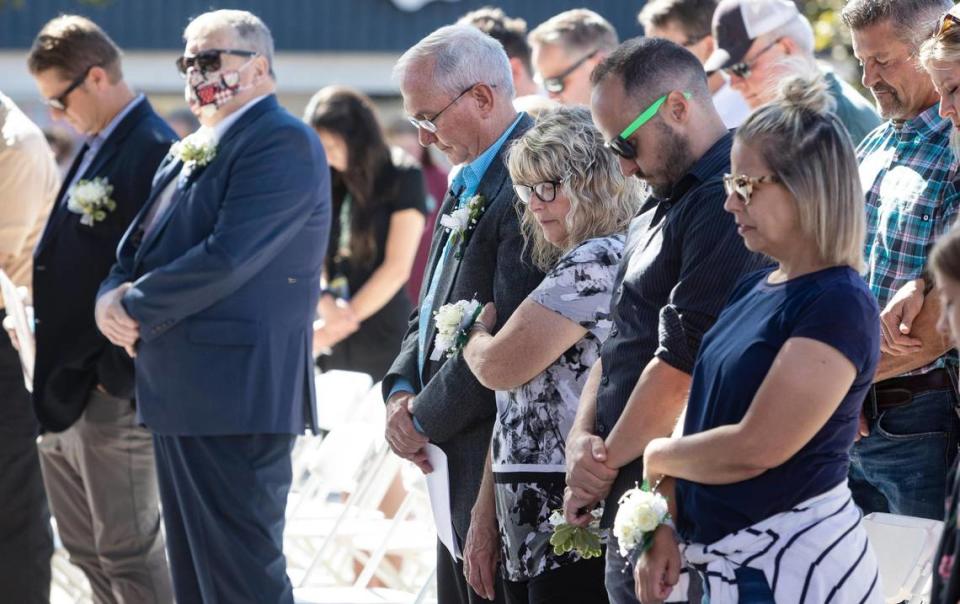 Caldwell Mayor Garret Nancolas, center, and his wife Pamela Nancolas stand in prayer during the invocation for the state of the city address on Sept. 23, 2021 at Indian Creek Plaza. Nancolas said his wife has been his rock in hard times and in sickness. He is looking forward to spending more time with her in his retirement.