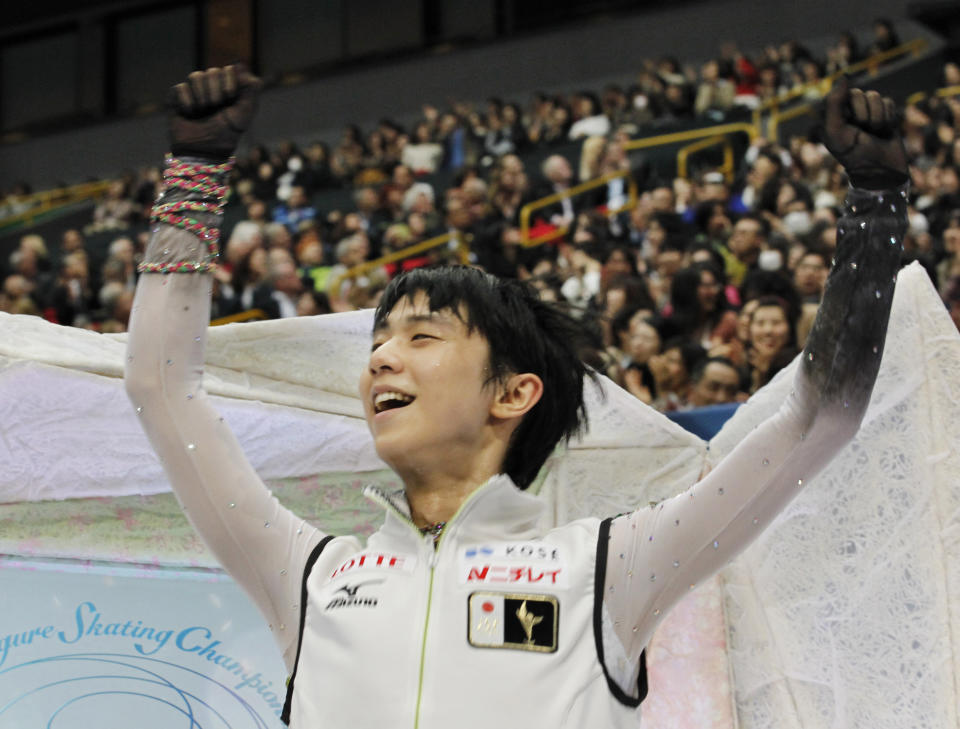 Yuzuru Hanyu of Japan reacts to his victory in the men's free skating finals of the World figure skating championships in Saitama near Tokyo, Friday, March 28, 2014. Hanyu barely topped the free skate to become the first man in 12 years on Friday to win the Olympic and world figure skating titles in the same year. (AP Photo/Koji Sasahara)