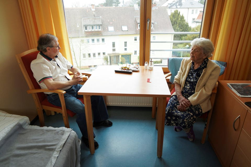 Holocaust survivor Raisa Valiushkevych, 98, who has recently escaped Russian bombing of her hometown Kyiv, sits with her son Vadym during a Reuters interview in Frankfurt, Germany April 1, 2022. Picture taken, April 1, 2022. REUTERS/Timm Reichert