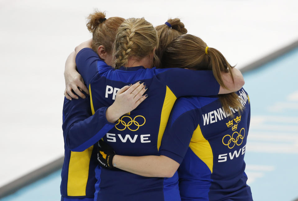Sweden celebrates their victory over Switzerland in the women's curling semifinal game against at the 2014 Winter Olympics, Wednesday, Feb. 19, 2014, in Sochi, Russia. (AP Photo/Robert F. Bukaty)