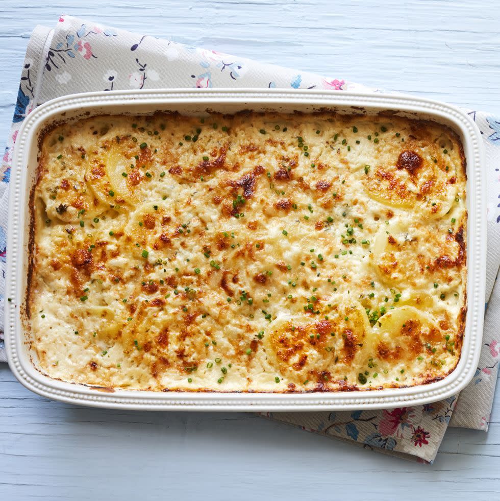 creamy potatoes with chives in white rectangular casserole with floral napkin